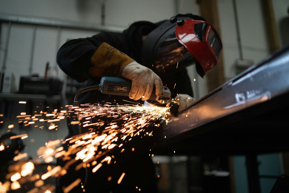 A worker cutting rebar on a site