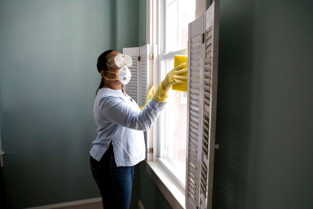 A cleaner working a window
